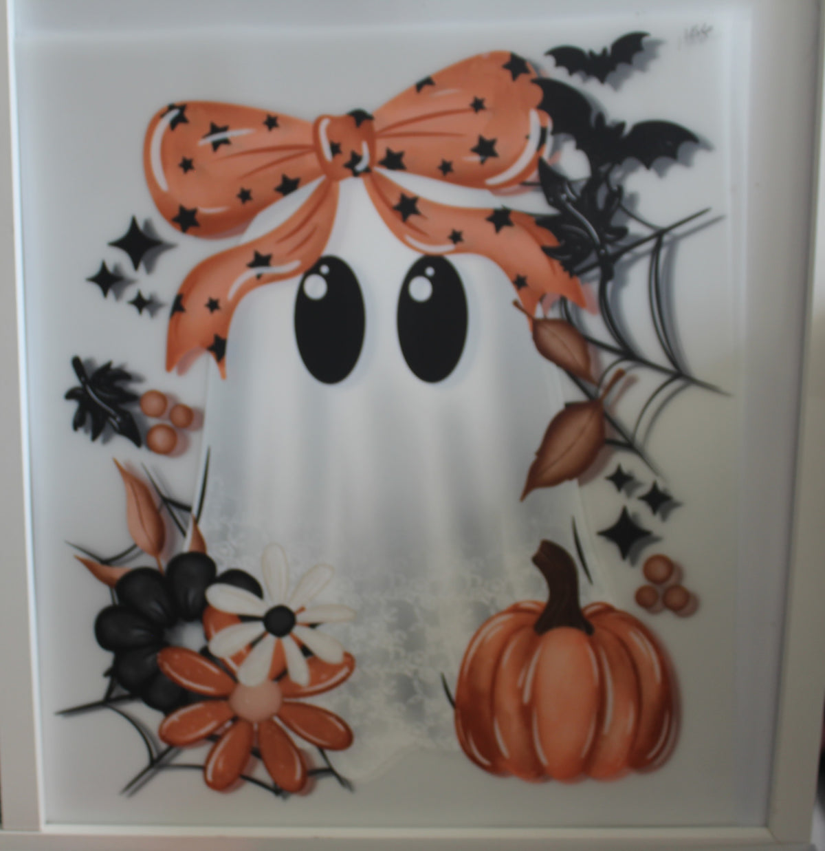 Cute ghost with orange bow and pumpkin and spider web.